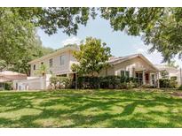 Charming two-story home with well-maintained landscaping and lush green lawn at 11802 Foxrun Ln, Temple Terrace, FL 33617
