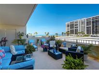 Relaxing balcony featuring comfortable outdoor seating with ocean views and tropical plants at 1480 Gulf Blvd # 109, Clearwater Beach, FL 33767