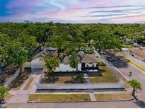 Charming fenced home with lush, mature landscaping and a detached two-car garage at 2322 21St S St, St Petersburg, FL 33712