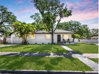 Charming single-story home features a well-maintained lawn, mature trees and a welcoming front porch at 2322 21St S St, St Petersburg, FL 33712