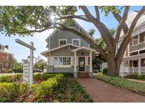 Charming two-story building with brick walkway, lush greenery, and mature trees offering a welcoming entrance at 337 S Plant Ave, Tampa, FL 33606