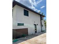 Rear view of home featuring a dark modern exterior door and clean architectural lines at 3911 6Th W Ave, Palmetto, FL 34221