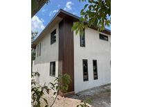 Modern two story home showcasing mixed siding, clean lines, and dark framed windows at 3911 6Th W Ave, Palmetto, FL 34221