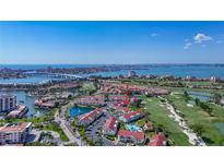 Beautiful aerial view of community featuring red roofs, golf course, and scenic water views at 6059 Bahia Del Mar Blvd # 235, St Petersburg, FL 33715