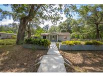 Charming single story home with landscaped front yard, inviting entryway and mature shady trees at 7211 & 0 Sunnyside Dr, Brooksville, FL 34601