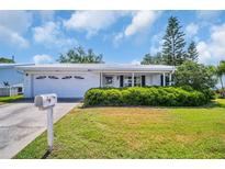 Charming home featuring a well-maintained lawn and a welcoming front entrance at 9136 42Nd N Ln, Pinellas Park, FL 33782