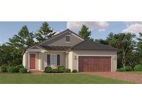 Charming single story home with a craftsman style elevation, manicured lawn, and attached two car garage at 11841 Sparkling Topaz Cv, Parrish, FL 34219