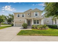 Charming two-story home features a well-manicured lawn, two-car garage, and lovely curb appeal at 14718 Rocky Brook Dr, Tampa, FL 33625