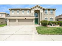 Charming two-story home with a three car garage, well manicured lawn, and freshly painted exterior at 20251 Ravens End Dr, Tampa, FL 33647