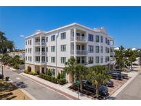 Beautiful condo building with balconies, manicured landscaping, and convenient parking spaces at 231 2Nd S St # 201, Safety Harbor, FL 34695