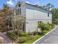 Charming two-story home featuring unique architectural detail, beautiful landscaping, and a well-maintained yard at 311 Vista Cruiser Ln, Oldsmar, FL 34677
