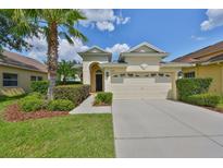 Charming single-story home with a two-car garage and well-manicured landscaping at 3315 Granite Ridge Loop, Land O Lakes, FL 34638
