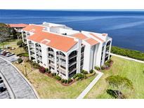 Stunning waterfront condo featuring a red tile roof and lush landscaping at 433 Mariner Dr # 433, Tarpon Springs, FL 34689