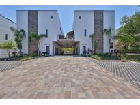 Stunning exterior view of modern townhomes with brick driveways and beautiful landscaping at 4910 W Mcelroy Ave # 6, Tampa, FL 33611