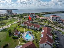 Beautiful aerial view of waterfront condos with a community pool and lush landscaping near the bay at 6011 Bahia Del Mar Blvd # 158, St Petersburg, FL 33715