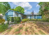 Charming single-story home featuring a well-maintained lawn and manicured shrubbery along the walkway at 7903 Heather Ct, Tampa, FL 33634