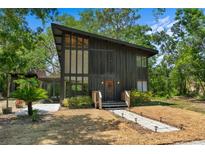 Unique home with striking architectural details and well-maintained landscaping at 18816 Carr Dr, Lutz, FL 33559