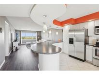 Open concept living room flows into the kitchen and offers amazing water views from a large window at 4725 Cove Cir # 604, St Petersburg, FL 33708
