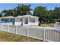 Charming single-story home featuring a white picket fence and well-maintained front yard at 4801 Haines N Rd, St Petersburg, FL 33714