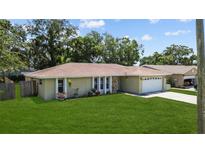 Charming single-story home with a well-manicured lawn and attached two-car garage at 9155 125Th St, Seminole, FL 33772
