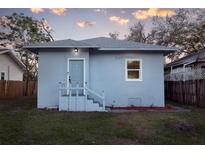 Charming home featuring a light blue exterior with a well-maintained front yard at 1045 22Nd N Ave, St Petersburg, FL 33704