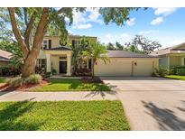 Charming two-story home features a well-manicured lawn and an attached three-car garage at 1133 Split Silk St, Valrico, FL 33594