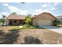 Charming single-Gathering home with a well-manicured lawn and stone accents at 1615 Loghill Pl, Brandon, FL 33510
