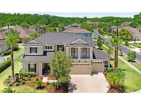 Beautiful two-story home featuring manicured landscaping, a three-car garage, and a welcoming front facade at 3243 Watermark Dr, Wesley Chapel, FL 33544