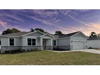Charming single-story home with a two-car garage, stone accents, and well-maintained landscaping at 37533 Teri Ct, Dade City, FL 33525