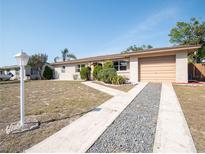 Charming one-story brick home featuring an attached garage and well-maintained landscaping at 6251 Danbury St, Spring Hill, FL 34606