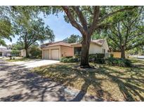 Charming villa-style home with well-maintained landscaping and a two-car garage at 826 Glades Ne Ct, St Petersburg, FL 33702