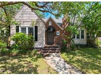 Charming home featuring a brick chimney, cozy front porch, and mature landscaping at 101 22Nd N Ave, St Petersburg, FL 33704