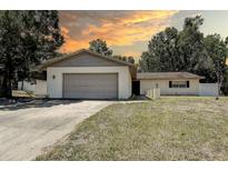 Charming single-story home with a two-car garage and well-maintained lawn, perfect for suburban living at 3728 Parkway Blvd, Land O Lakes, FL 34639