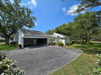 Charming home with a well-maintained lawn and long driveway leading to a spacious two-car carport at 4175 Northmeadow Cir # 4175, Tampa, FL 33618
