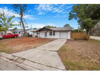 Charming single-story home with a long driveway and attached garage, ready for new owners at 5911 63Rd N Ter, Pinellas Park, FL 33781