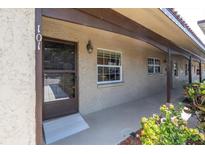 Inviting front porch with brown door and window, leading into a charming home at 601 N Hercules Ave # 101, Clearwater, FL 33765