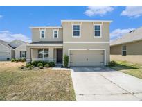 Charming two-story home with a two car garage and well-maintained front lawn at 6967 Silverado Ranch Blvd, Zephyrhills, FL 33541