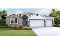 Charming single-Gathering home showcasing a stone facade and a well-manicured lawn at 10657 Bridgegate Heights Loop, San Antonio, FL 33576
