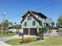 Two-story home with a unique design, a well-maintained lawn, and distinctive architectural features at 5341 Circle Dr, Weeki Wachee, FL 34607