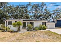 Charming home featuring an elegantly landscaped front yard and attached garage at 5415 Park Pl, Tampa, FL 33603
