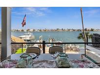 Breathtaking waterfront views from the dining table, overlooking the boat dock and serene water at 5820 Balao S Way, St Pete Beach, FL 33706