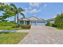 Charming one-story home featuring a three-car garage, well-manicured landscaping and a paver driveway at 6440 Maiden Sea Dr, Apollo Beach, FL 33572