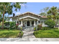 Charming bungalow with a manicured lawn and beautiful landscaping, creating great curb appeal at 1001 S Oregon Ave, Tampa, FL 33606