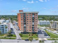 A full exterior view of a modern building with balconies and a well-maintained lawn at 1120 N Shore Ne Dr # 201, St Petersburg, FL 33701