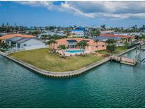 Stunning waterfront home featuring a private pool, dock, and lush landscaping at 11625 5Th E St, Treasure Island, FL 33706