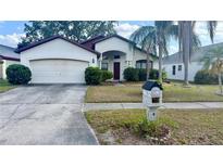 Charming single-story home featuring a well-maintained front yard, two-car garage, and inviting front entrance at 1510 Sakonnet Ct, Brandon, FL 33511