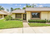 Charming single-story home featuring a well-manicured lawn and inviting entrance at 2537 Oakleaf Ln # 32A, Clearwater, FL 33763