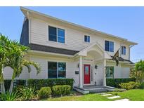 Charming two-story home with a manicured lawn, a red front door, and lush landscaping at 3008 S Church Ave, Tampa, FL 33629