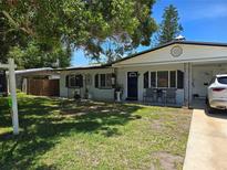 Charming single-story home with a well-manicured lawn and cozy front porch area at 315 Shore E Dr, Oldsmar, FL 34677