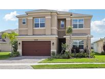 Stunning two-story home featuring manicured landscaping and an attached two-car garage at 3488 Great Banyan Way, Wesley Chapel, FL 33543